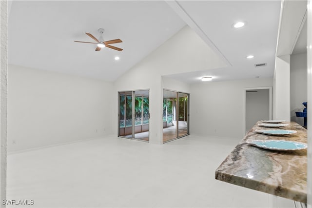 interior space featuring ceiling fan and high vaulted ceiling