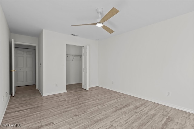 unfurnished bedroom with a closet, ceiling fan, and light hardwood / wood-style flooring