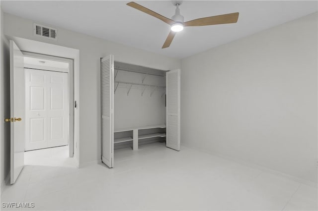 3352 Timberwood Cir, Naples, FL 34105 - unfurnished bedroom featuring a closet, ceiling fan, tile patterned flooring, and baseboards