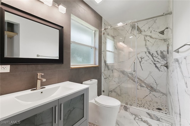 bathroom with toilet, vanity, tile walls, and walk in shower