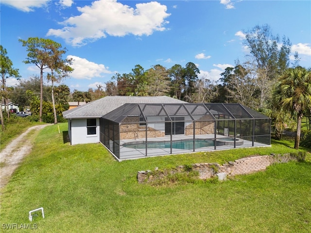 view of swimming pool featuring a lanai and a yard