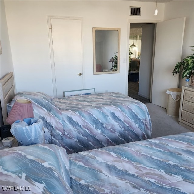 carpeted bedroom with visible vents