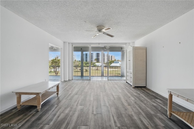 8401 Estero Blvd Unit 204, Fort Myers Beach, FL 33931 - unfurnished living room featuring wood finished floors, ceiling fan, a textured ceiling, and baseboards