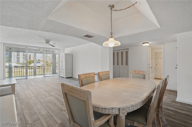 8401 Estero Blvd Unit 204, Fort Myers Beach, FL 33931 - dining space featuring wood finished floors, a textured ceiling, and a ceiling fan