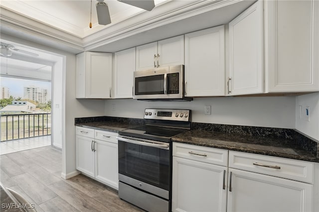 8401 Estero Blvd Unit 204, Fort Myers Beach, FL 33931 - kitchen featuring stainless steel appliances, a ceiling fan, light wood-style flooring, white cabinetry, and dark stone counters