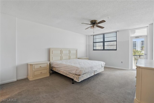 8401 Estero Blvd Unit 204, Fort Myers Beach, FL 33931 - bedroom featuring carpet floors, a textured ceiling, baseboards, access to exterior, and ceiling fan