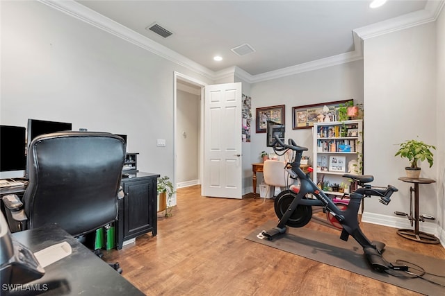 home office featuring crown molding and light hardwood / wood-style floors