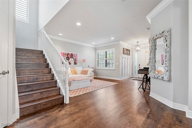 interior space featuring ornamental molding, dark wood-type flooring, and a notable chandelier