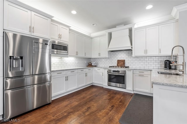 kitchen featuring sink, stainless steel appliances, custom exhaust hood, white cabinets, and dark wood-type flooring