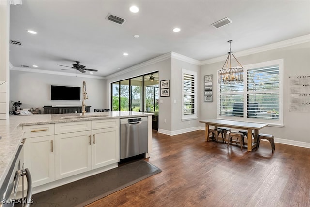 kitchen with dark hardwood / wood-style floors, light stone countertops, pendant lighting, stainless steel dishwasher, and ceiling fan with notable chandelier