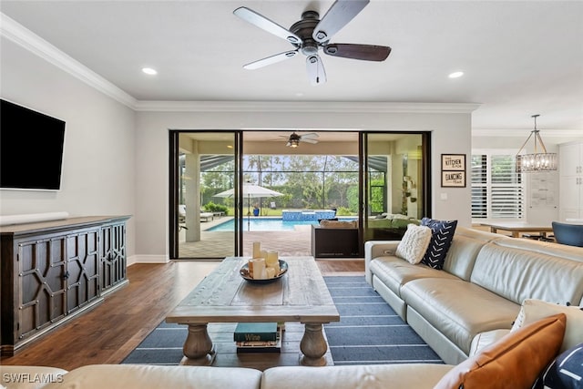 living room with dark wood-type flooring, crown molding, and a wealth of natural light