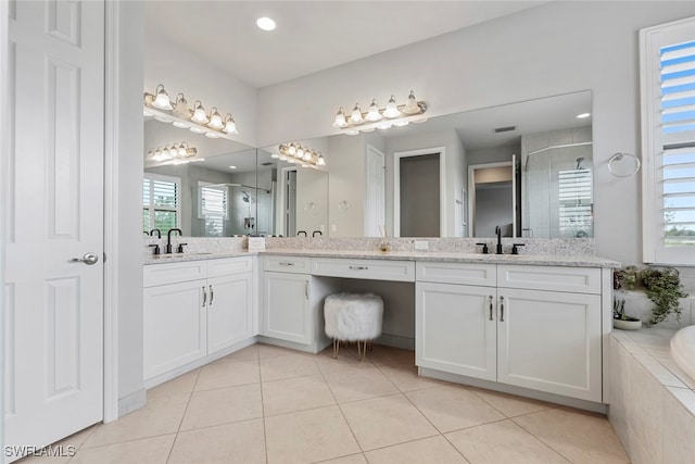 bathroom with vanity, separate shower and tub, and a wealth of natural light