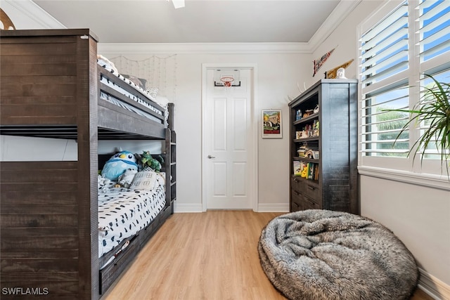 bedroom featuring crown molding and hardwood / wood-style flooring