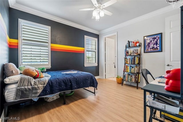 bedroom featuring crown molding, multiple windows, hardwood / wood-style flooring, and ceiling fan