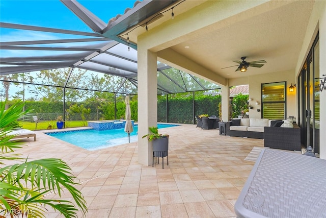 view of pool with outdoor lounge area, a patio area, and glass enclosure