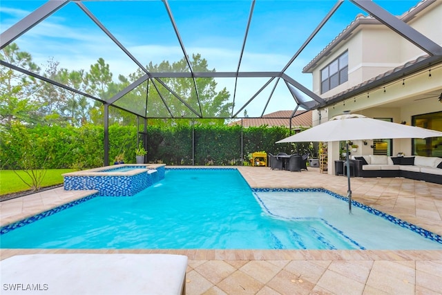 view of swimming pool with an in ground hot tub, a patio area, glass enclosure, ceiling fan, and an outdoor living space