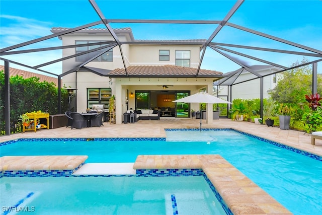 rear view of property featuring outdoor lounge area, ceiling fan, a patio area, and a lanai