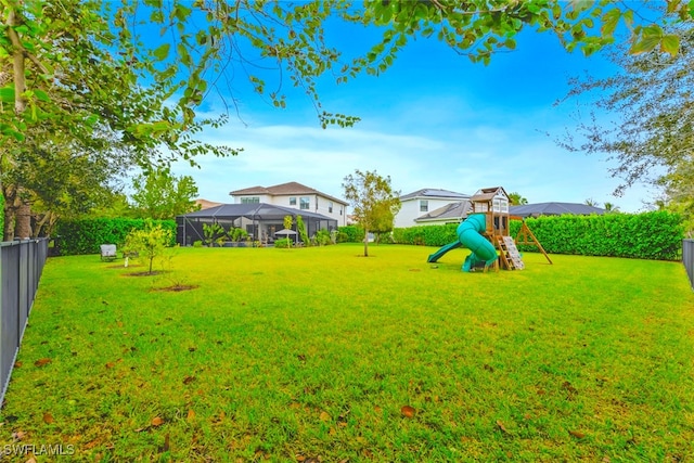 view of yard featuring a playground and a lanai