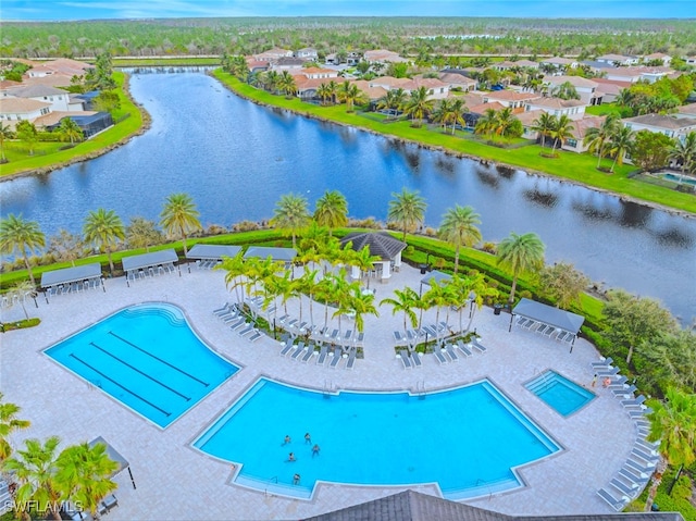 view of pool with a patio area and a water view