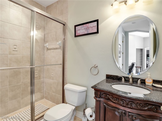 bathroom with a shower with door, vanity, and toilet