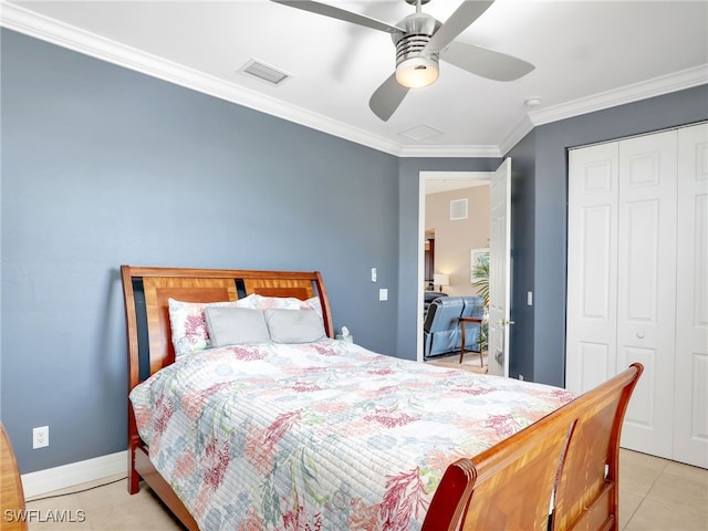 bedroom featuring ceiling fan, light tile patterned floors, crown molding, and a closet