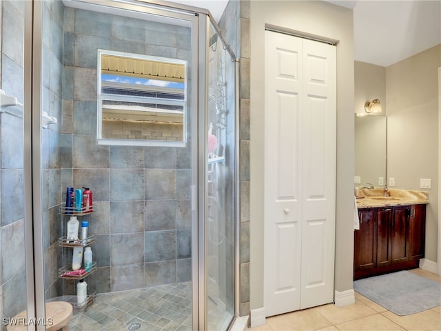 bathroom featuring tile patterned flooring, vanity, and a shower with door