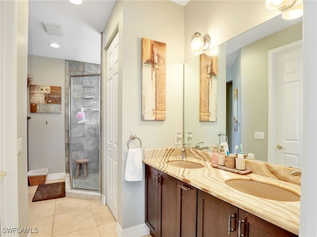 bathroom featuring tile patterned floors, vanity, and walk in shower