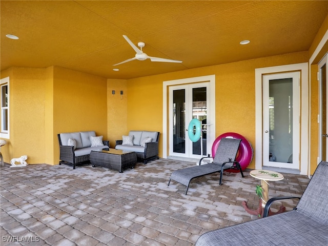 view of patio with an outdoor living space and ceiling fan