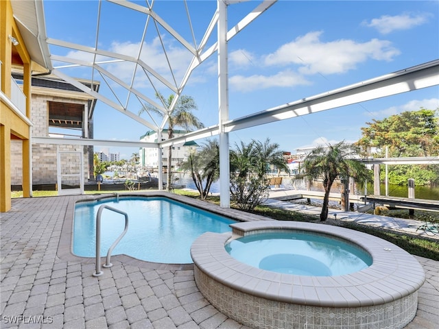 view of pool with a patio area, a lanai, and an in ground hot tub