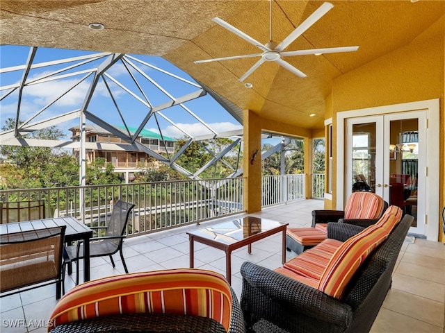 view of patio / terrace with a lanai, outdoor lounge area, ceiling fan, and french doors