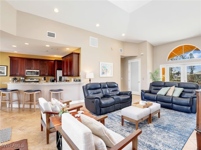 living room featuring a high ceiling and french doors