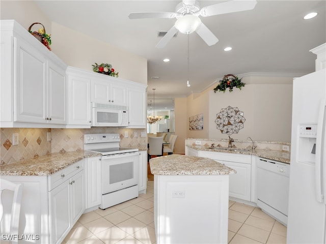 kitchen with sink, a center island, white cabinets, white appliances, and tasteful backsplash