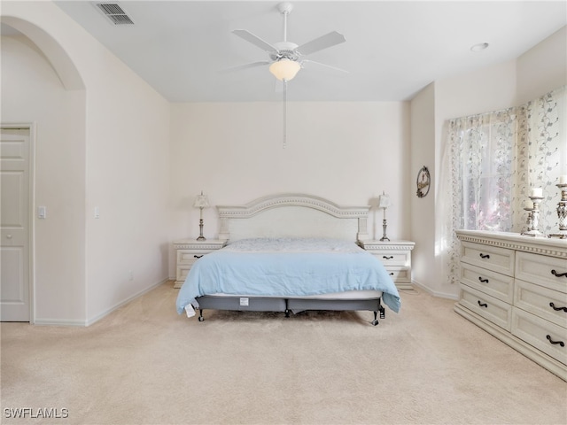 bedroom featuring light colored carpet and ceiling fan