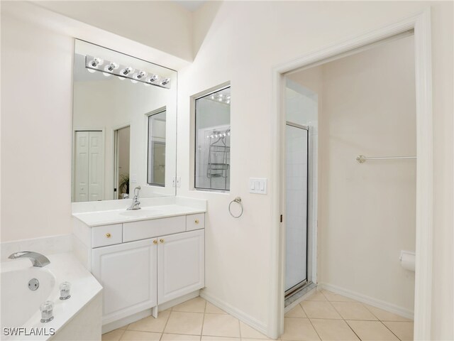 bathroom with vanity, shower with separate bathtub, and tile patterned flooring