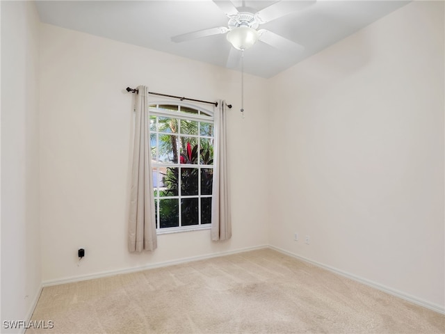 spare room featuring ceiling fan and light colored carpet