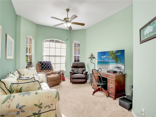 carpeted office space featuring ceiling fan