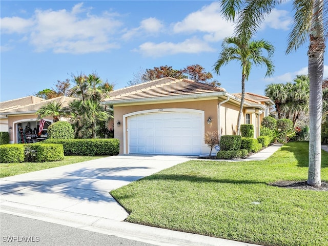 view of front of home featuring a front yard and a garage