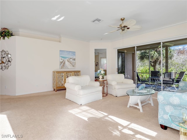 living room featuring light carpet, crown molding, and ceiling fan