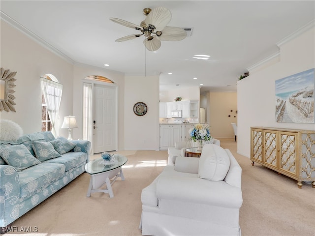 carpeted living room featuring ceiling fan and ornamental molding