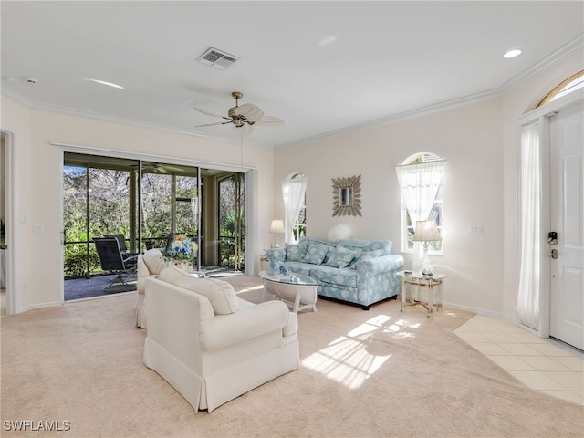 living room featuring light carpet, ornamental molding, and ceiling fan