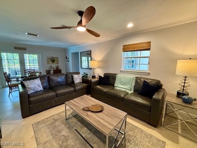 living room featuring ornamental molding, ceiling fan, and light tile patterned flooring