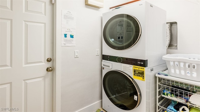 laundry area with stacked washer and dryer