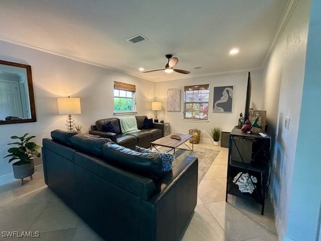 living room with ornamental molding, ceiling fan, and light tile patterned flooring