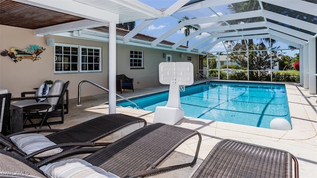 view of swimming pool featuring a lanai and a patio