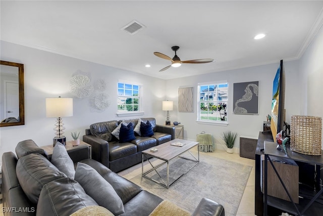 living room with ornamental molding, a wealth of natural light, ceiling fan, and light tile patterned floors