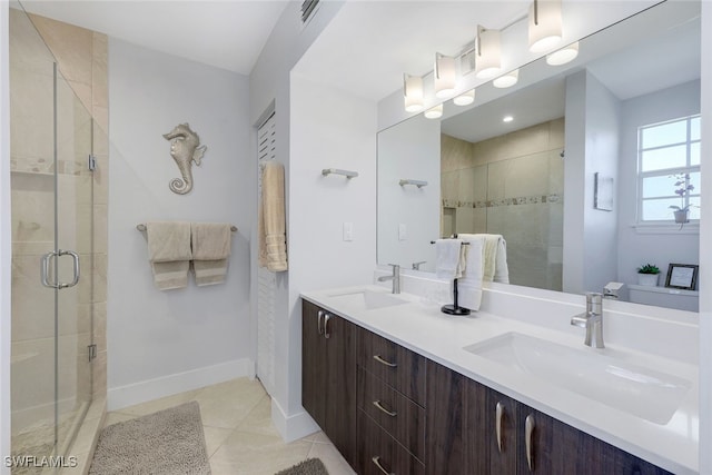 bathroom with tile patterned floors, a shower with shower door, and vanity