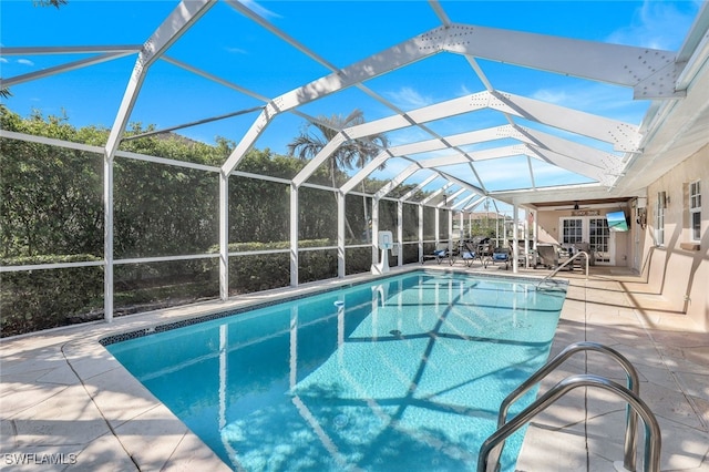 view of pool featuring a lanai, ceiling fan, and a patio area