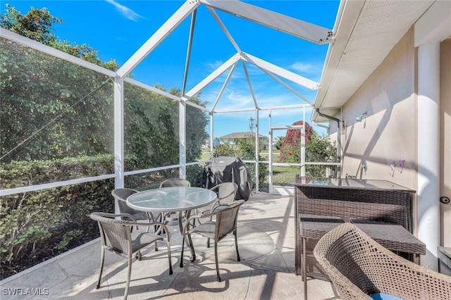 view of patio / terrace featuring a grill and a lanai