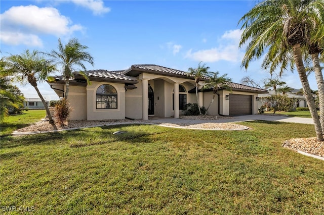 mediterranean / spanish-style house with a garage and a front lawn