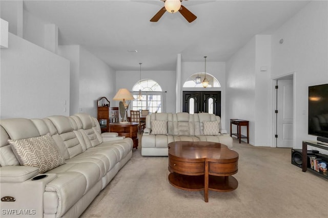 25373 Tether Ln, Punta Gorda, FL 33983 - living room with ceiling fan, light carpet, and a high ceiling
